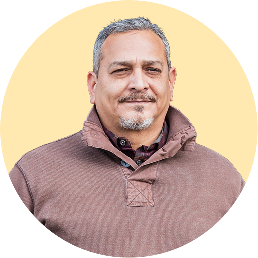 Hispanic man in front of a yellow background