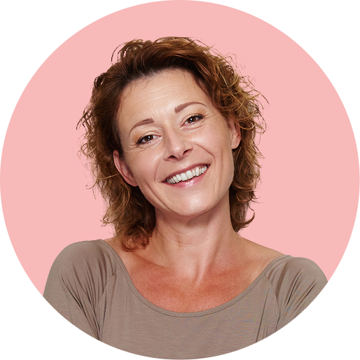 Woman smiling in front of a red background