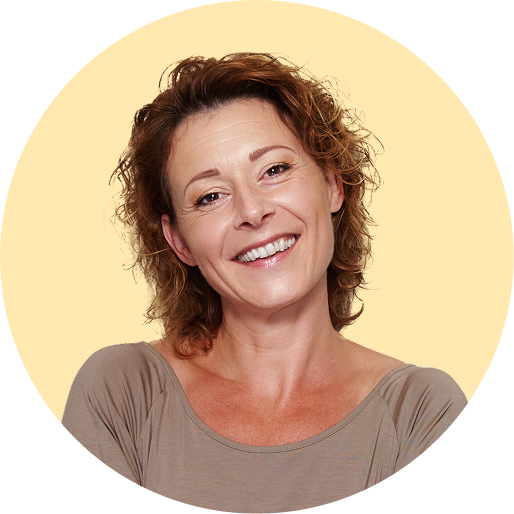 Woman smiling in front of a yellow background