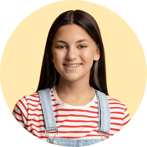 Young teen girl smiling in front of a yellow background