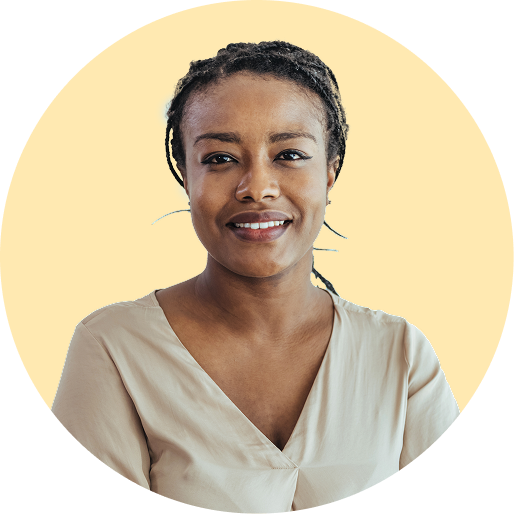 Black woman smiling in front of a yellow background